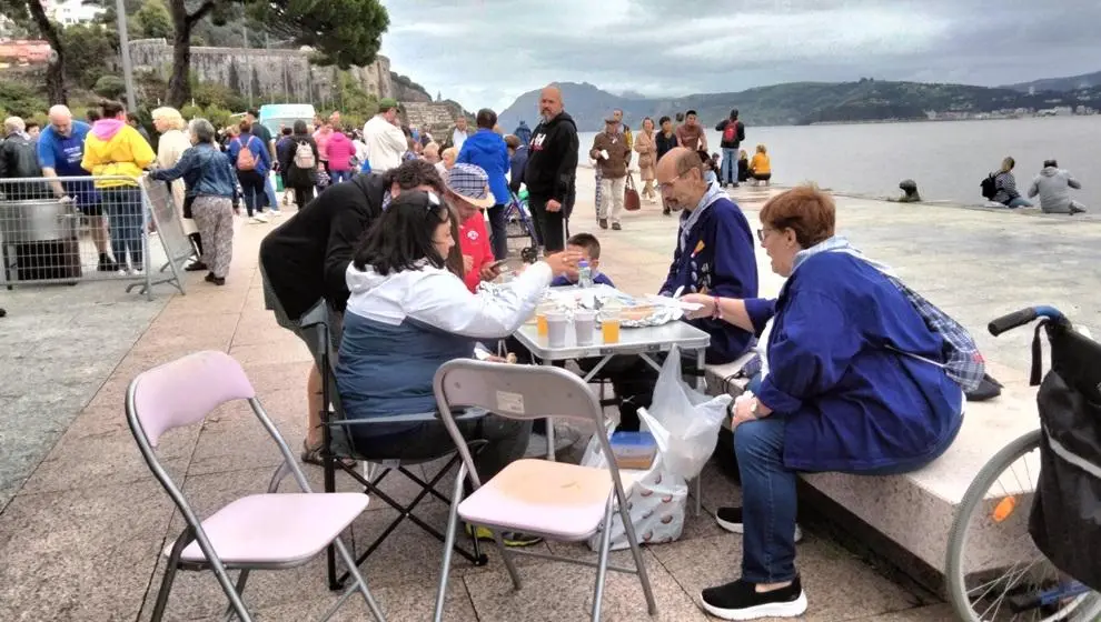 Mesas de asistentes para comer el plato. R.A.