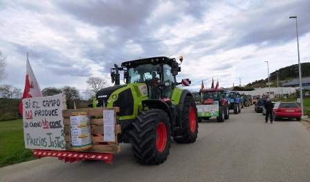 Los ganaderos llegaron con tractores y pancartas a la empresa Lácteos de Santander, en Meruelo. R.A